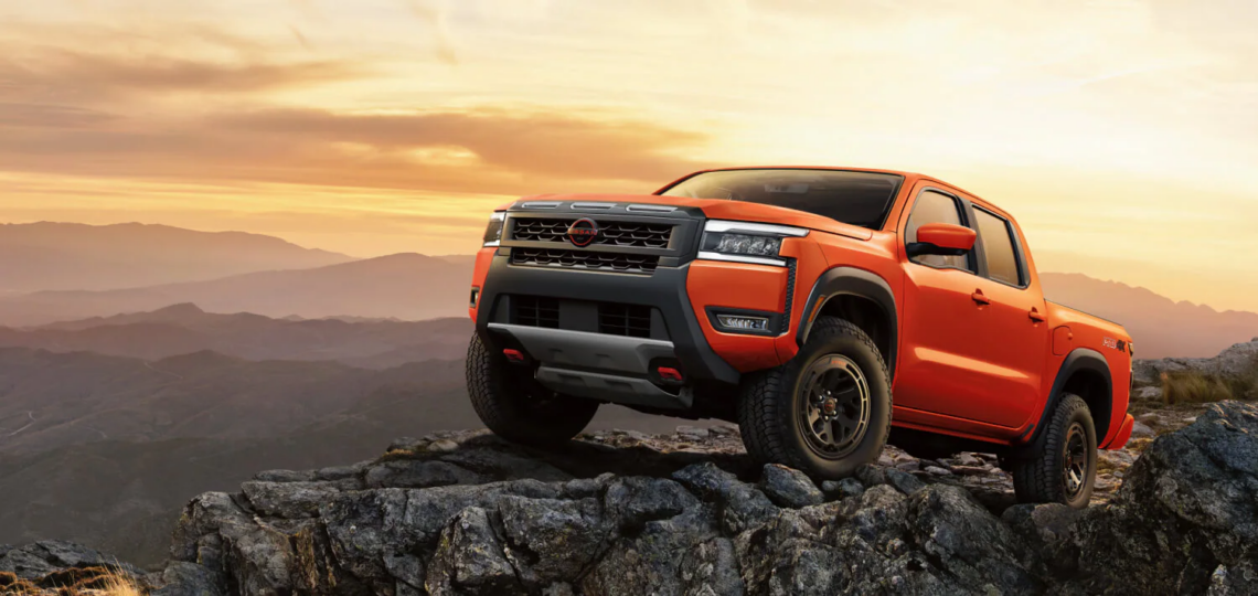 The 2026 Nissan Frontier atop a mountainscape